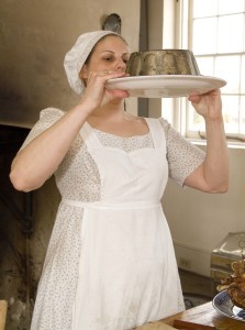 Foodways historian Joyce White turns out a cake in the open-hearth kitchen during "The 1812 Woman of Riversdale" weekend. Photo courtesy M-NCPPC.