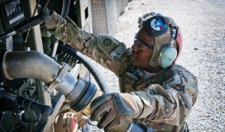 Spc. Alfred Kollie at his fuel truck. As a U.S. Army petroleum-supply specialist, he provides aviation support to ground forces in Afghanistan. Photo courtesy Eric Pahon. 