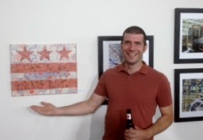 Artist Matt Carl with his mixed media collage work - partially made of postage stamps. (September 5, 2013)