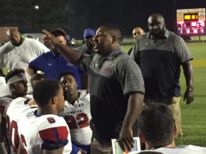 DeMatha Football Coach Elijah Brooks instructs his team following the Stags' 42-7 victory at Oscar Smith High School in Chesapeake, Va., on Aug. 26. Photo courtesy of Chris McManes