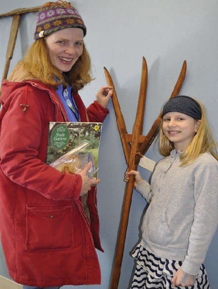 Hyattsville gardener Geraldine Hall and daughter Caelan Rice (9) get a close-up look at antique tools at the HHSʼs Fourth Annual Hart Seed Sale.  Photo courtesy Deidre McQuade.