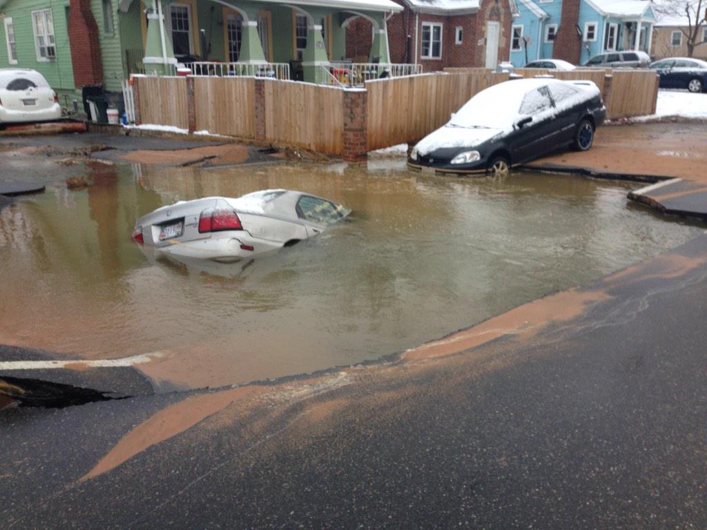 A family escaped a vehicle before it was swallowed by a sinkhole. Photo courtesy WSSC.