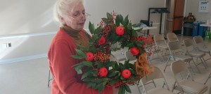 woman holding wreath of greens